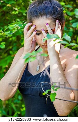 Stock Image - Teen girl in a park.. Fotosearch
