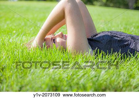 Stock Photo - Teen girl in a park.. Fotosearch