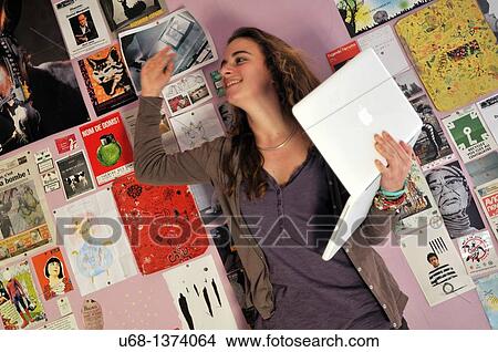 Teen girl in her bedroom with laptop computer View Large Photo Image Picture - Teen girl in her bedroom with laptop computer. Fotosearch