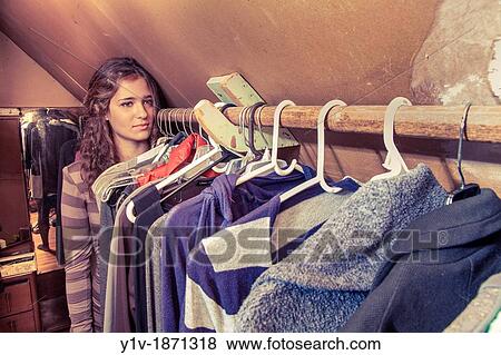 Stock Photo - Teen girl in her mother's clothes closet. Fotosearch
