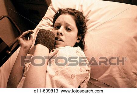 Stock Image - Teen girl in hospital bed. Fotosearch