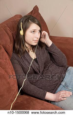 Stock Photo - Teen girl listening to music on her headset. Fotosearch