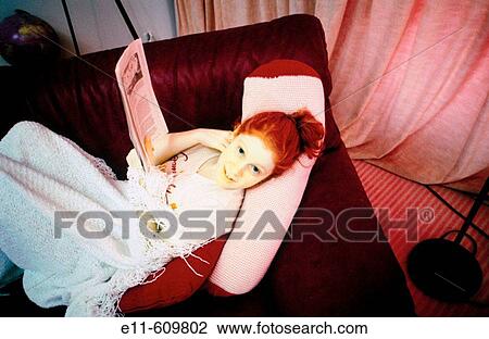 Teen girl lying on a couch View Large Photo Image Stock Image - Teen girl lying on a couch. Fotosearch