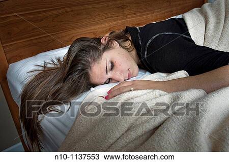 Teen girl lying on her bed View Large Photo Image Stock Image - Teen girl lying on her bed. Fotosearch