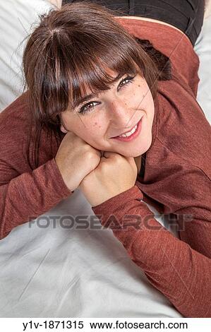 Stock Photography - Teen girl on her bed. Fotosearch