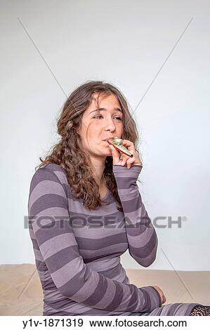 Stock Photo - Teen girl playing a kazoo. Fotosearch