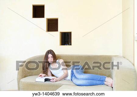Teen girl reading a book View Large Photo Image Stock Photo - Teen girl reading a book. Fotosearch
