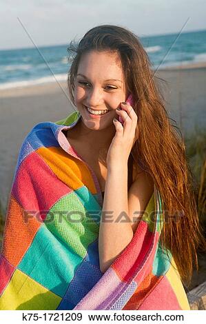 Teen girl talking on phone at beach View Large Photo Image Stock Photo - Teen girl talking on phone at beach. Fotosearch