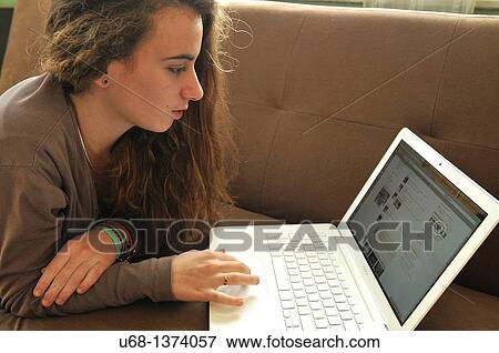 Stock Photo - Teen girl using laptop computer. Fotosearch