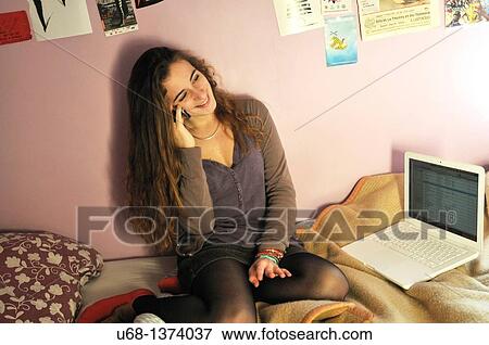 Teen girl using with cell phone and laptop computer View Large Photo Image Stock Photo - Teen girl using with cell phone and laptop computer. Fotosearch