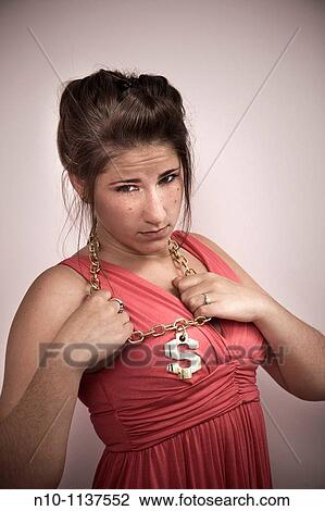 Teen girl wearing a necklace with an American money symbol attached to it View Large Photo Image Stock Image - Teen girl wearing a necklace with an American money symbol attached to it. Fotosearch