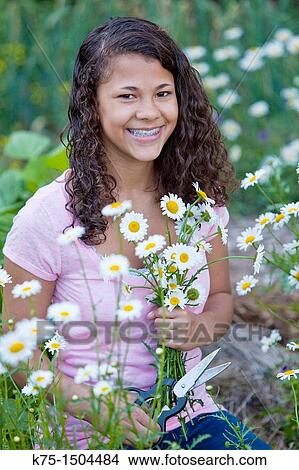 Teen girl with a bouquet of daisies View Large Photo Image Picture - Teen girl with a bouquet of daisies. Fotosearch