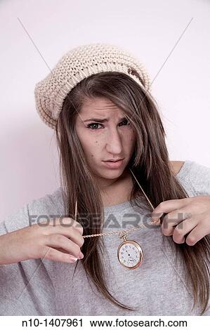 Stock Image - Teen girl with a pocket watch around her neck. Fotosearch