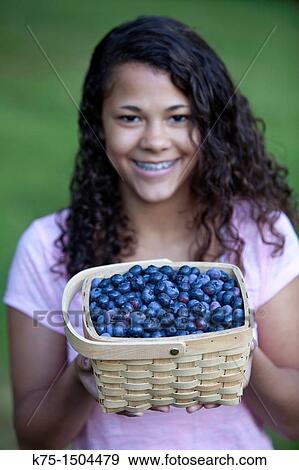Teen girl with basket of blueberries View Large Photo Image Stock Photo - Teen girl with basket of blueberries. Fotosearch