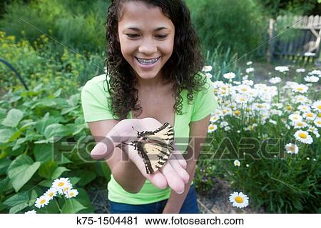 Teen girl with butterfly in her hand View Large Photo Image Stock Image - Teen girl with butterfly in her hand. Fotosearch