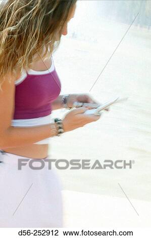 Stock Image - Teen girl with cell phone. Fotosearch