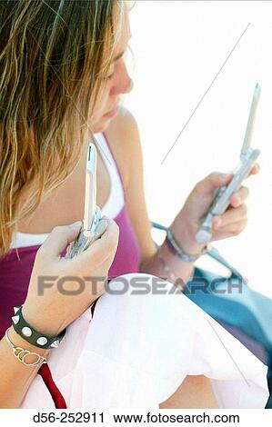 Teen girl with cell phones View Large Photo Image Stock Image - Teen girl with cell phones. Fotosearch