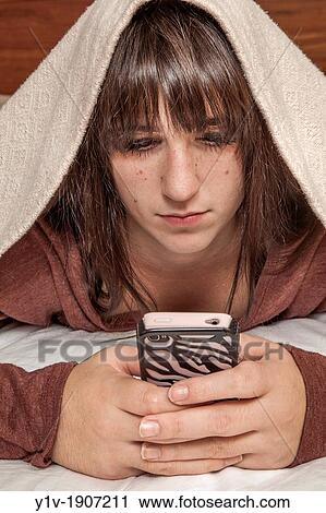 Teen girl with her smart phone View Large Photo Image Stock Image - Teen girl with her smart phone. Fotosearch