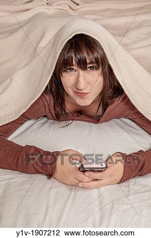 Teen girl with her smart phone View Large Photo Image Stock Image - Teen girl with her smart phone. Fotosearch