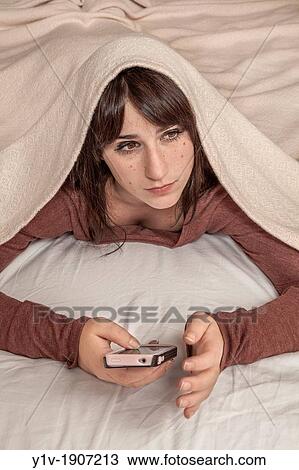Teen girl with her smart phone View Large Photo Image Stock Image - Teen girl with her smart phone. Fotosearch