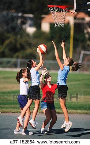 Picture - Teen girls playing basketball. Fotosearch