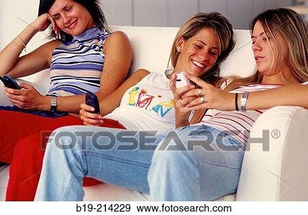Stock Photo - Teen girls with cellular phone. Fotosearch