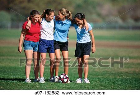 Stock Image - Teen girls with soccer ball. Fotosearch