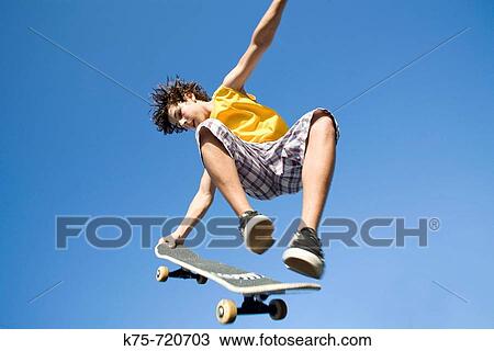 teen in the air with skateboard View Large Photo Image Stock Image - teen in the air with skateboard. Fotosearch