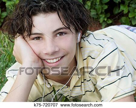 Teen listening to MP 3 player View Large Photo Image Stock Photo - Teen listening to MP 3 player. Fotosearch