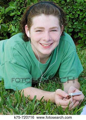 teen listening to music on mp3 player View Large Photo Image Stock Photograph - teen listening to music on mp3 player. Fotosearch