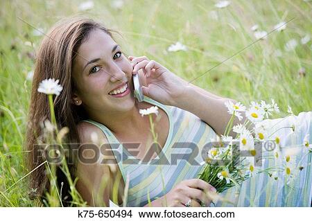 Teen on cell phone outdoors View Large Photo Image Picture - Teen on cell phone outdoors. Fotosearch