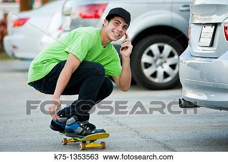 teen on skateboard and cell phone View Large Photo Image Stock Image - teen on skateboard and cell phone. Fotosearch