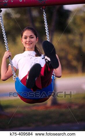 Teen on swing View Large Photo Image Picture - Teen on swing. Fotosearch