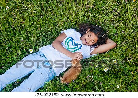 Teen petting kitten View Large Photo Image Stock Image - Teen petting kitten. Fotosearch
