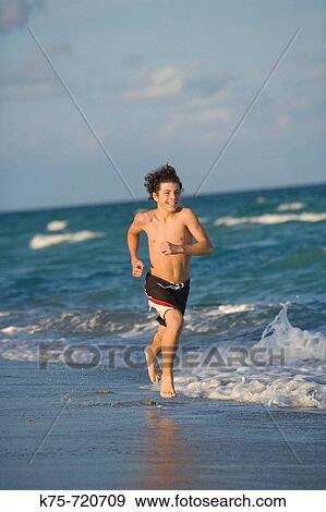 teen running on beach View Large Photo Image Stock Photo - teen running on beach. Fotosearch