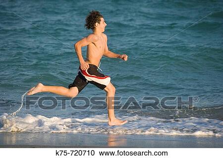 teen running on the beach View Large Photo Image Stock Image - teen running on the beach. Fotosearch