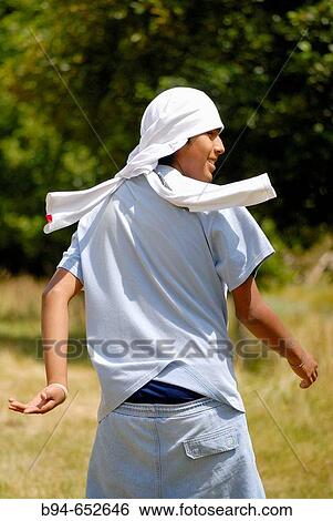 Teen running with a t-shirt on his head View Large Photo Image Stock Photograph - Teen running with a t-shirt on his head. Fotosearch
