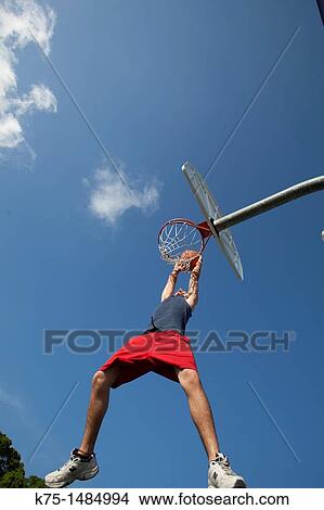 Teen shooting basketball into hoop View Large Photo Image Picture - Teen shooting basketball into hoop. Fotosearch