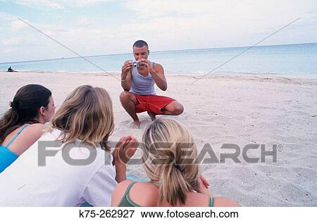 Teen taking digital photo at beach View Large Photo Image Stock Photo - Teen taking digital photo at beach. Fotosearch