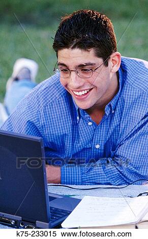 Teen using laptop outdoors View Large Photo Image Stock Photography - Teen using laptop outdoors. Fotosearch