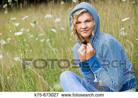 Teen wearing blue hoodie in field View Large Photo Image Stock Photo - Teen wearing blue hoodie in field. Fotosearch
