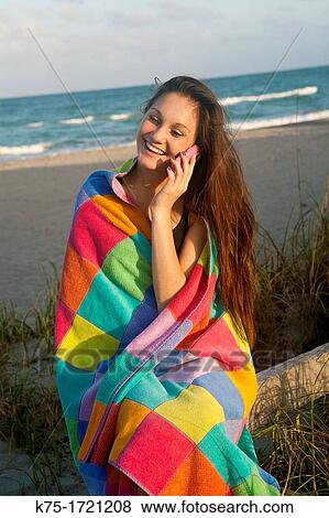 Teen wrapped in towel talking on cell phone View Large Photo Image Stock Photo - Teen wrapped in towel talking on cell phone. Fotosearch
