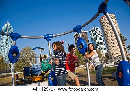 Teenage boy and girls playing in interactive children's playground at Curtis Hixon Waterfront Park View Large Photo Image Stock Photo - Teenage boy and girls playing in interactive children's playground at Curtis Hixon Waterfront Park. Fotosearch