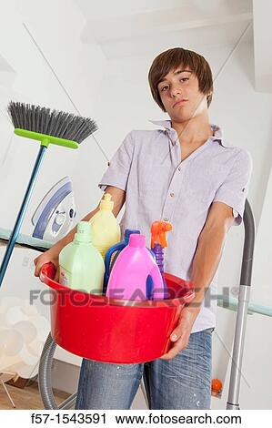 Teenage boy bored with housework View Large Photo Image Stock Image - Teenage boy bored with housework. Fotosearch