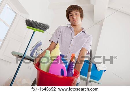 Teenage boy bored with housework View Large Photo Image Stock Image - Teenage boy bored with housework. Fotosearch