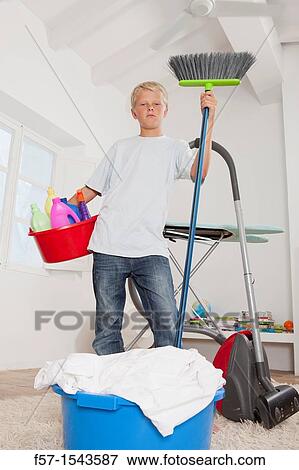 Teenage boy bored with housework View Large Photo Image Stock Photo - Teenage boy bored with housework. Fotosearch
