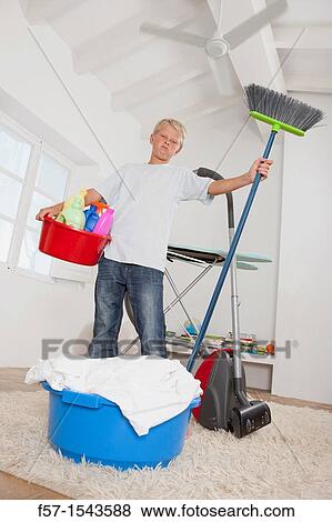 Teenage boy bored with housework View Large Photo Image Stock Photo - Teenage boy bored with housework. Fotosearch