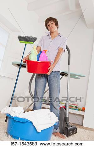Teenage boy bored with housework View Large Photo Image Stock Photo - Teenage boy bored with housework. Fotosearch
