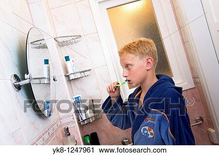 Teenage Boy Brushing Teeth in Bathroom View Large Photo Image Stock Image - Teenage Boy Brushing Teeth in Bathroom. Fotosearch