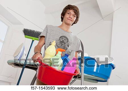 Teenage boy doing housework View Large Photo Image Stock Image - Teenage boy doing housework. Fotosearch